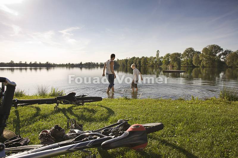 Radfahrer erfrischen sich am See
